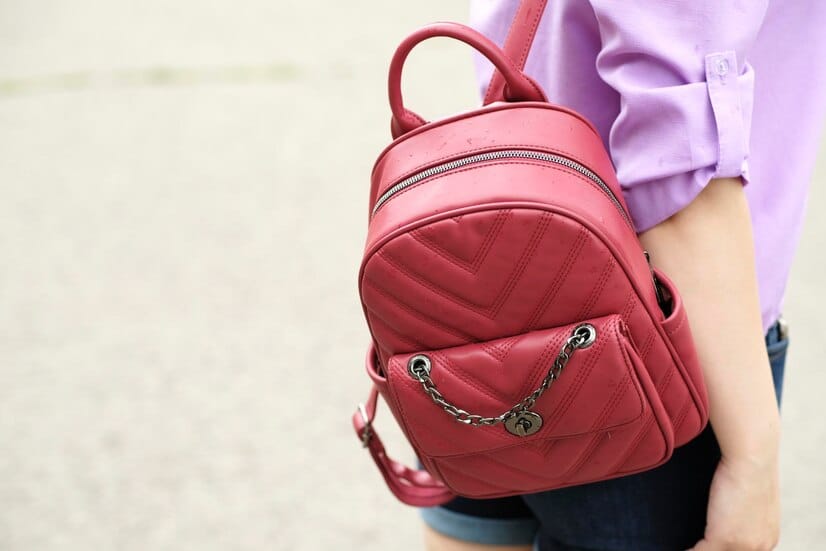 red-casual-backpack-hanging-unrecognizable-woman-close-up_629315-4077